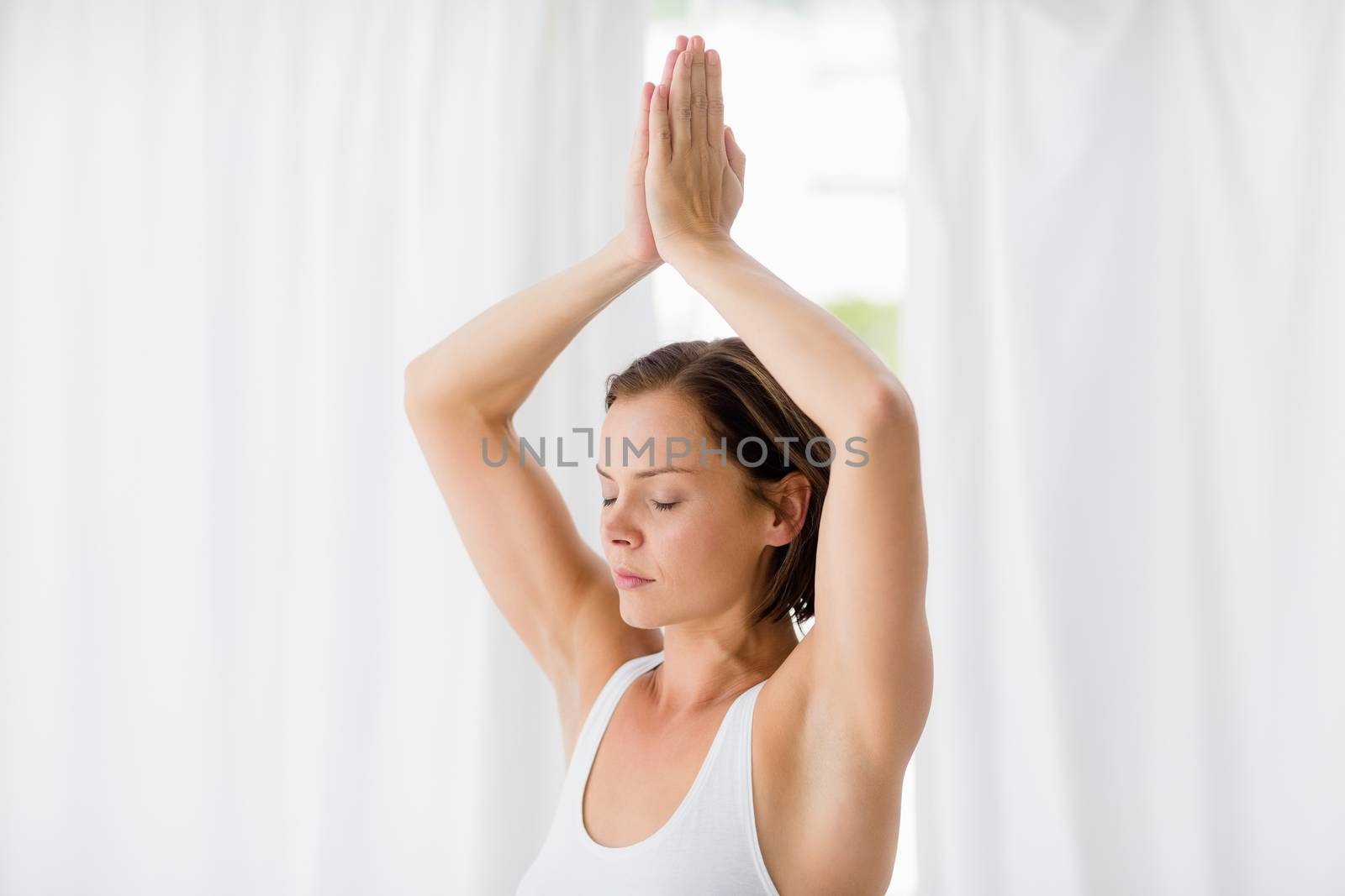 Woman with eyes closed doing yoga by Wavebreakmedia