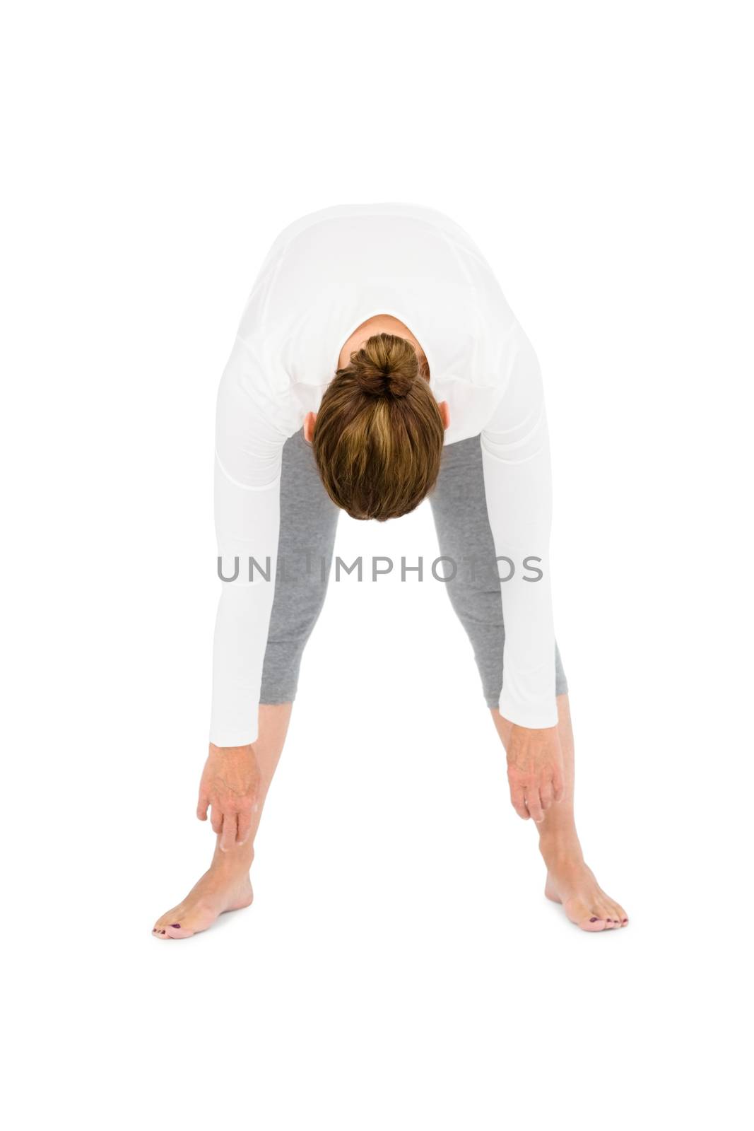 Full length of woman bending while exercising on white background
