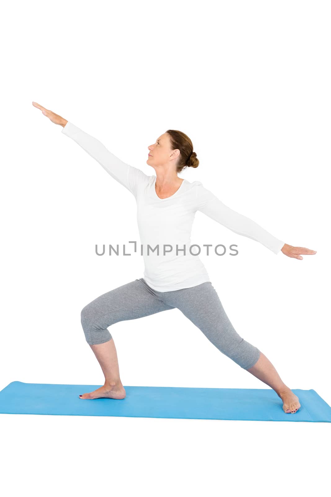 Full length of woman with arms outstretched while exercising on while background