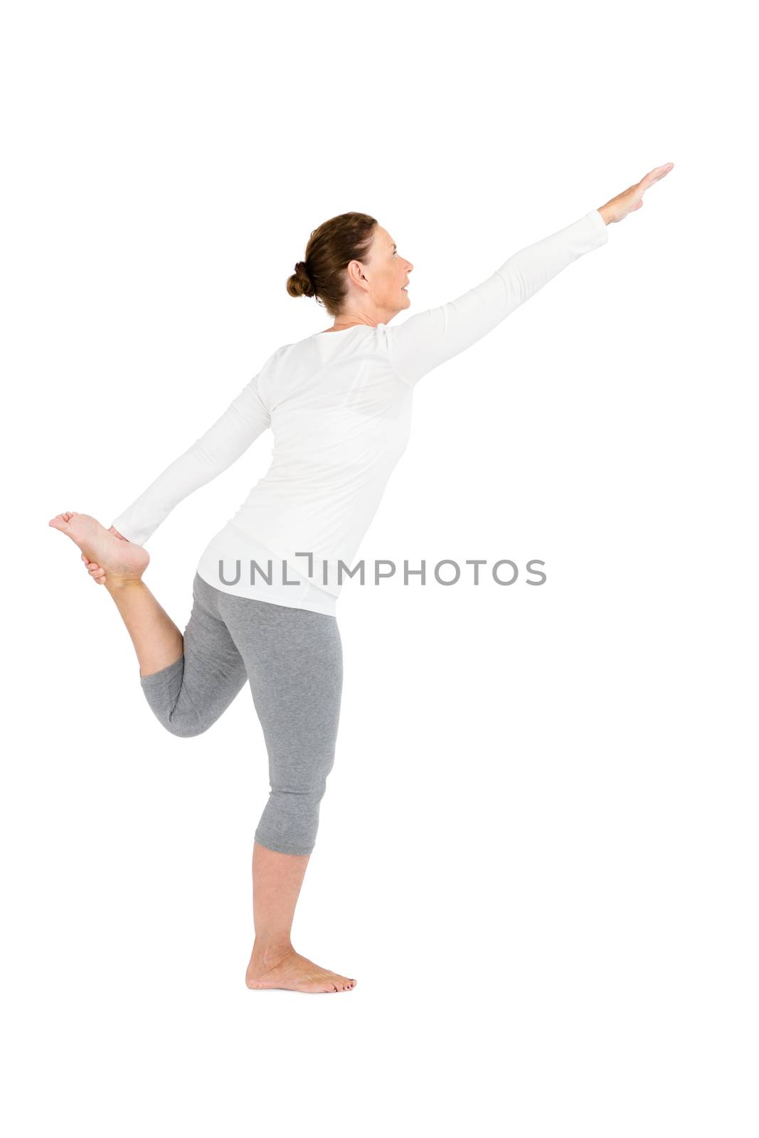 Full length of mature woman exercising on while background