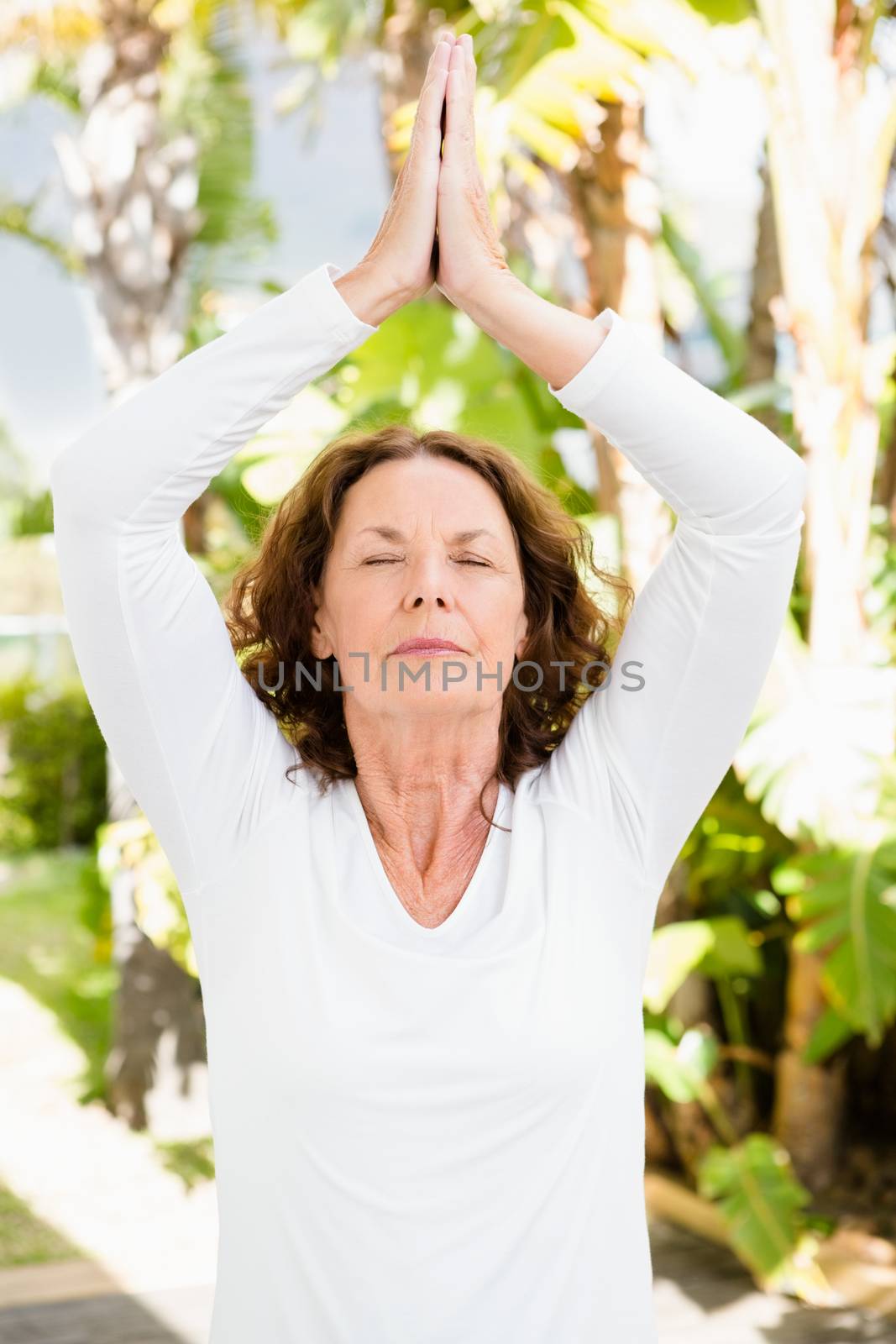 Woman with eyes closed while practicing yoga by Wavebreakmedia