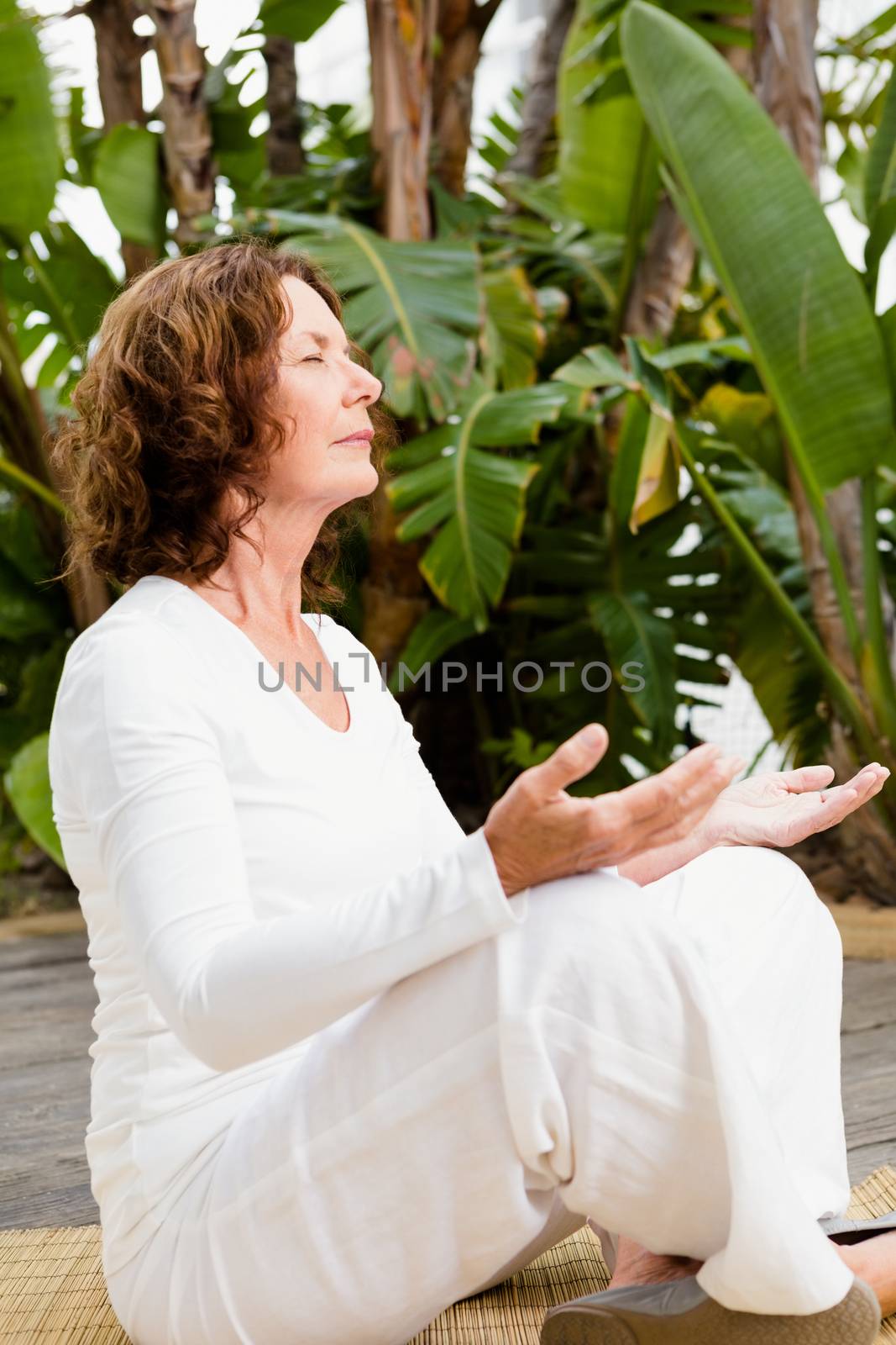 Relaxed woman doing yoga by Wavebreakmedia