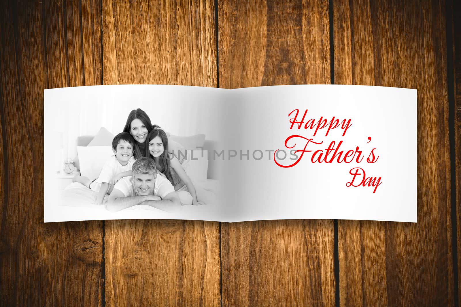 Attractive smiling father with family against overhead of wooden planks