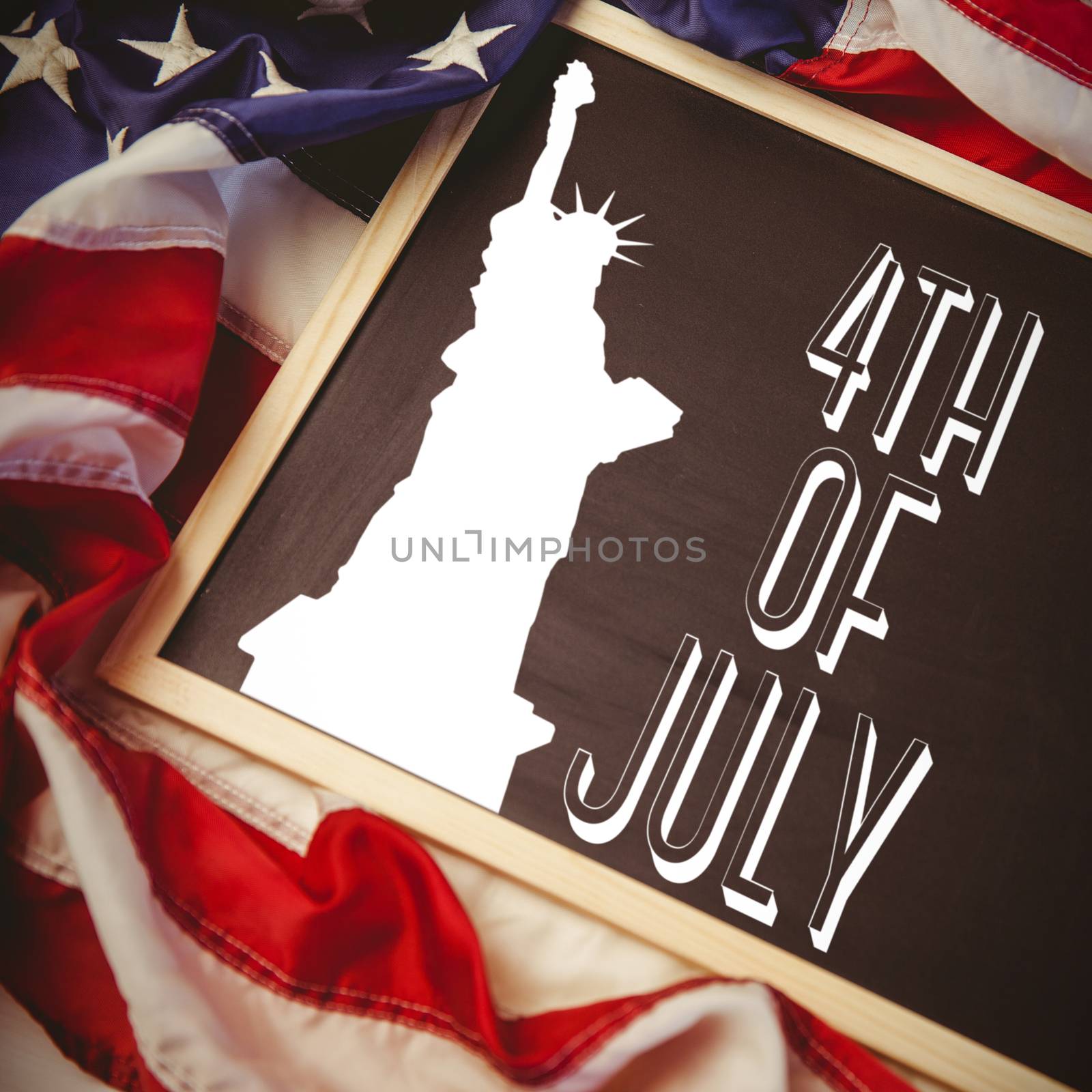 Independence day graphic against american flag on chalkboard