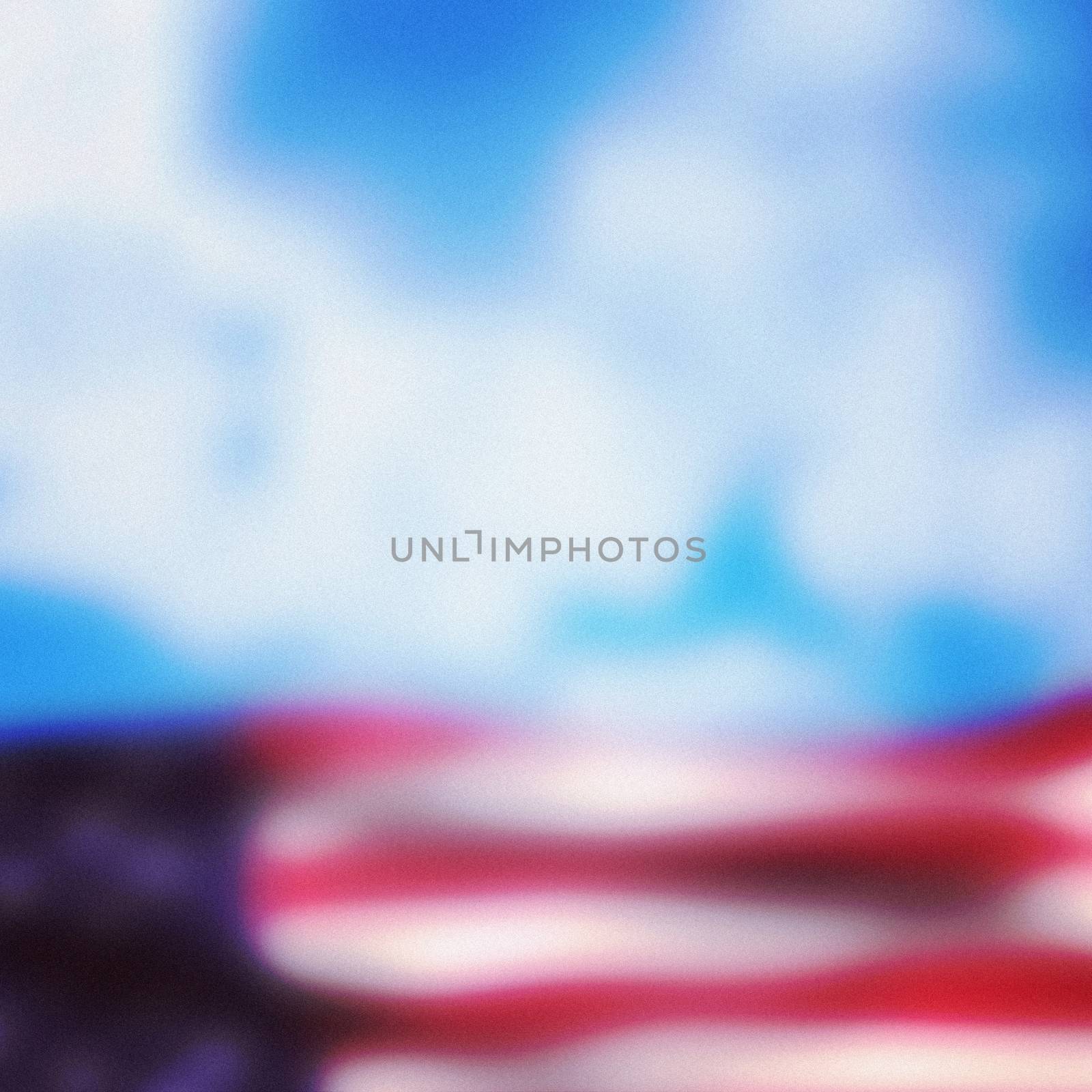 Close-up of American flag against cloudy sky background