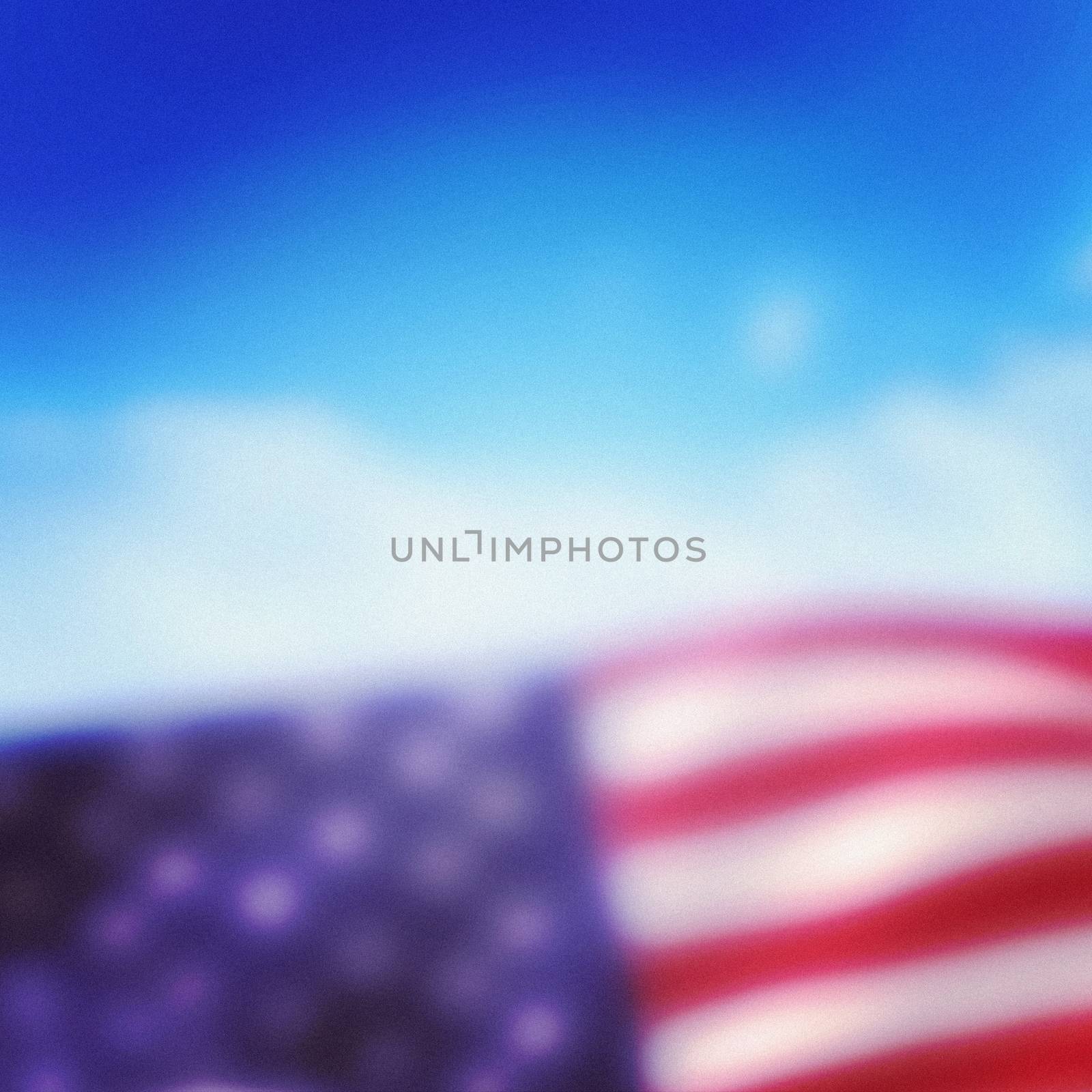 Close-up of American flag against cloudy sky background