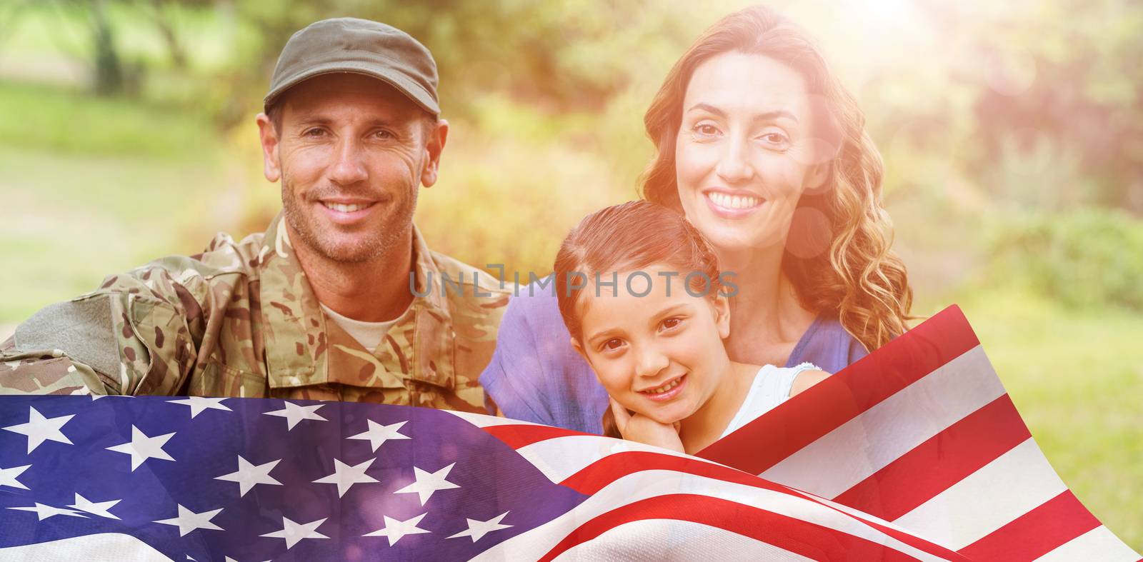 Portrait of army man with family against focus on usa flag