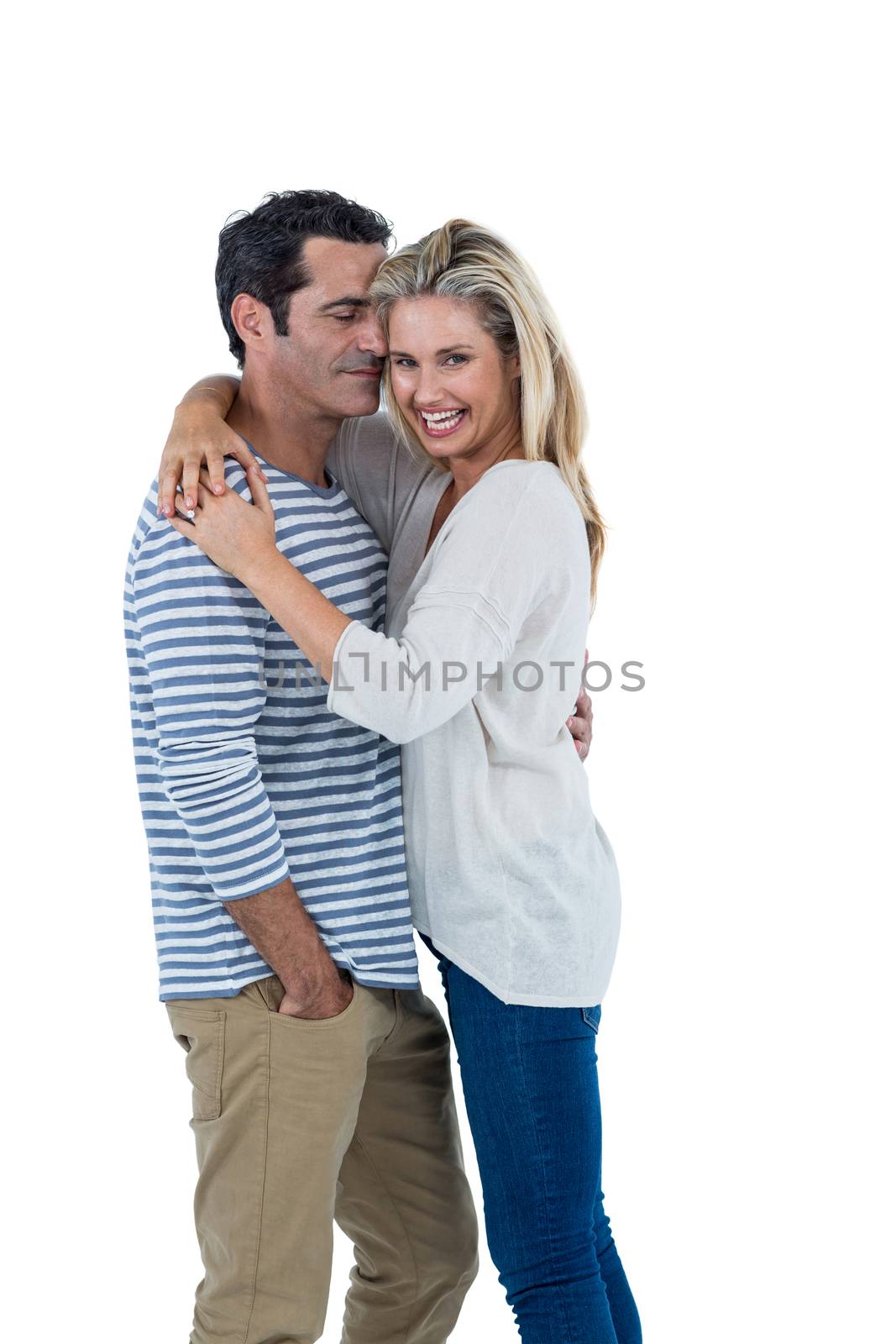 Happy mid adult romantic couple hugging against white background