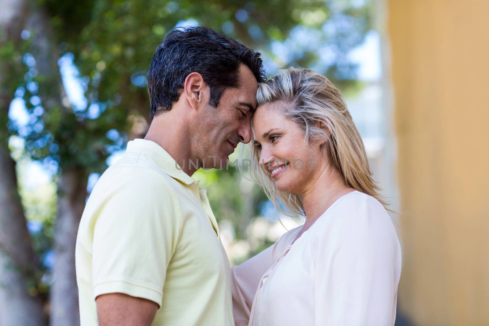 Romantic couple standing by building by Wavebreakmedia