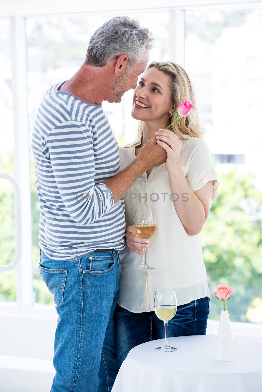 Romantic mature couple standing face to face at restaurant