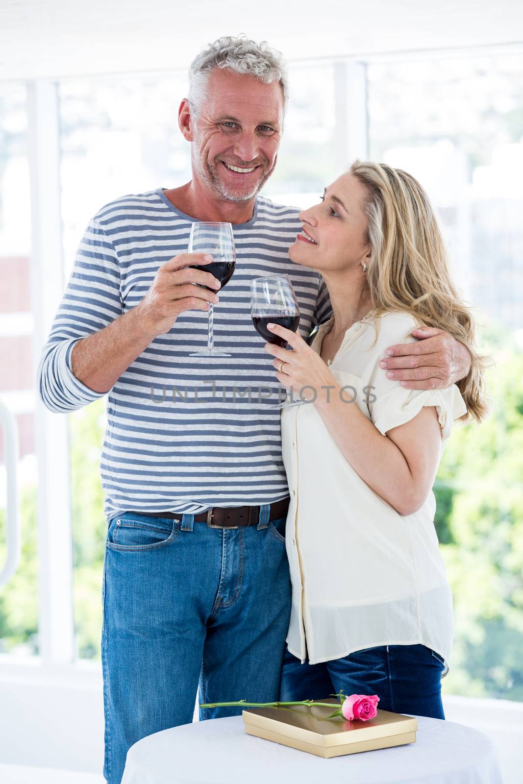 Romantic mature couple with red wine by Wavebreakmedia