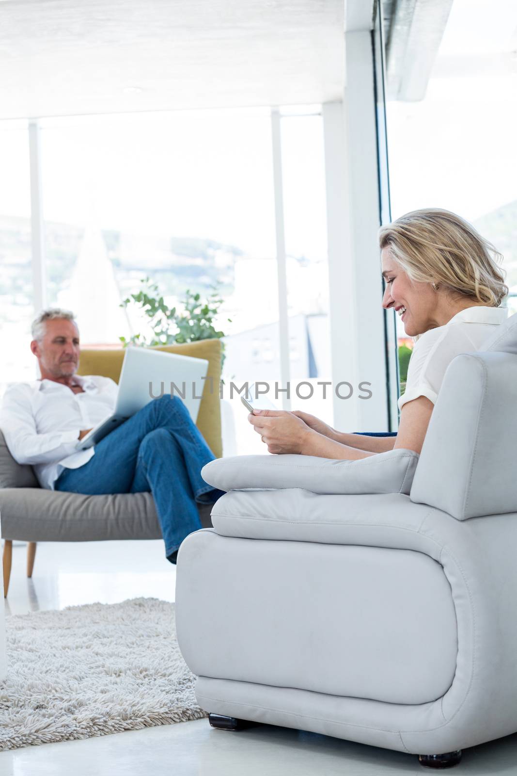 Couple using technology while sitting at home