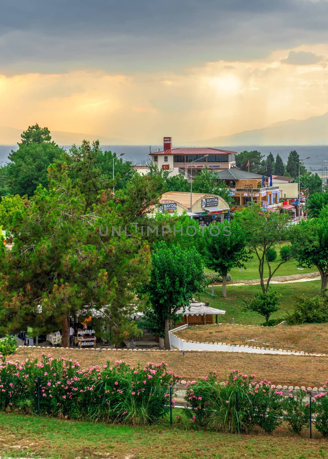 Pamukkale, Turkey – 07.14.2019. Panoramic view of Pamukkale village on a cloudy summer evening.