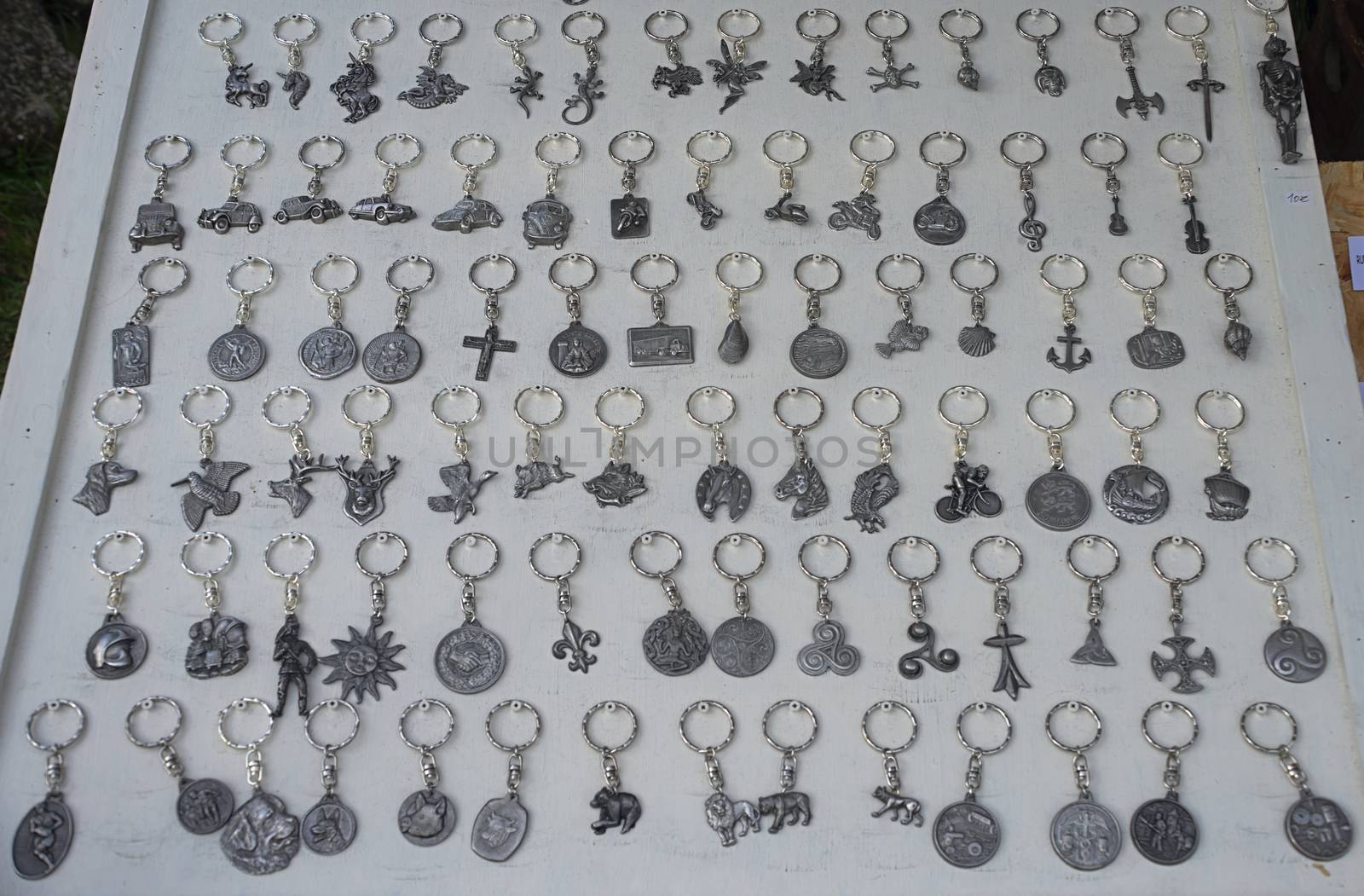 Abundance of key pendants on white table for sale