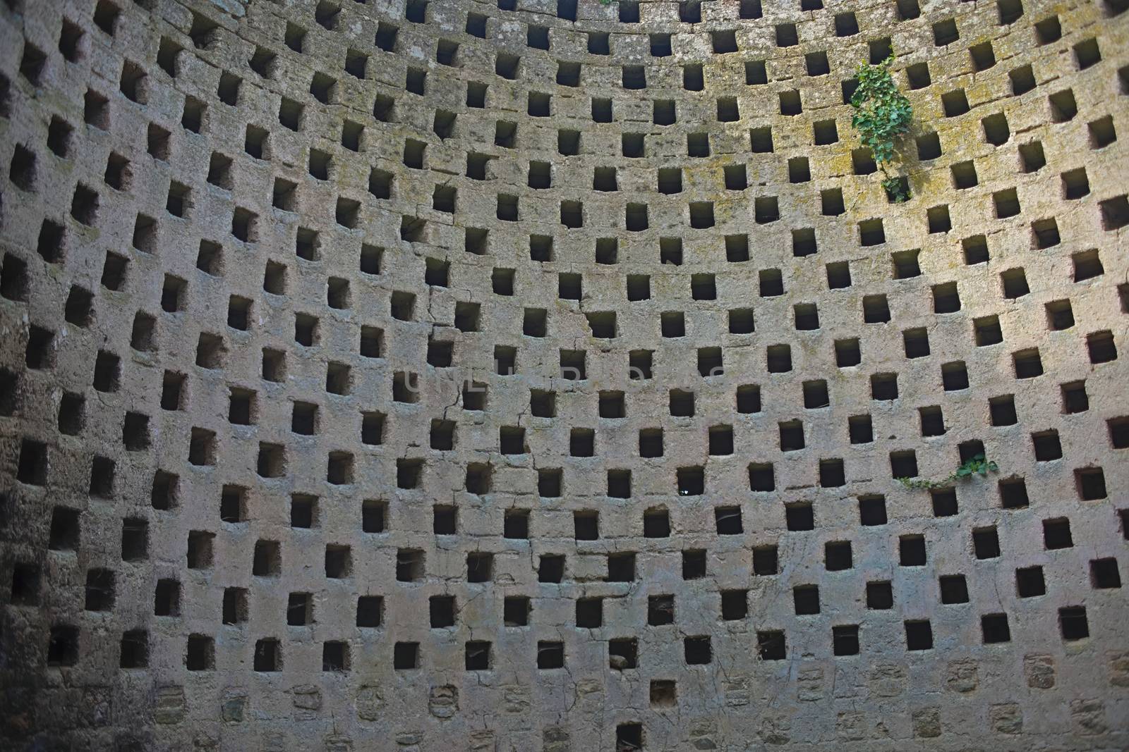 Round stone wall with many holes on an even distance by sheriffkule