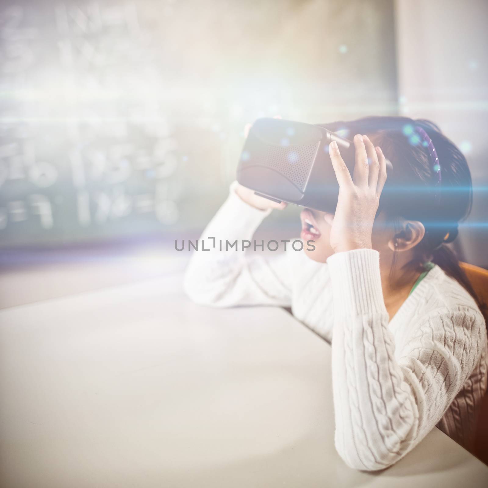 Little girl using virtual reality glasses at school