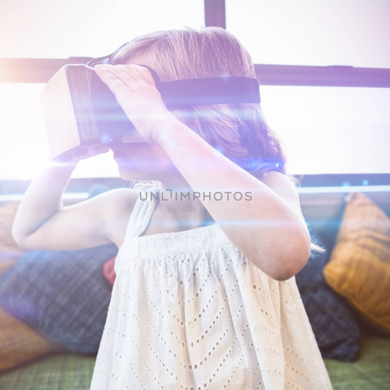 Young girl using a virtual reality device at home