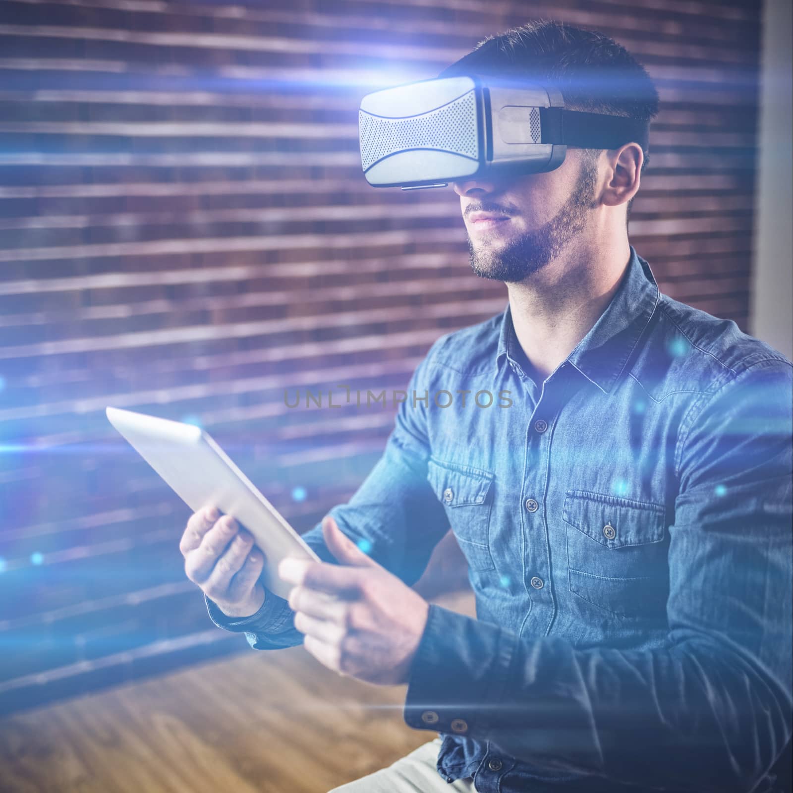 Man wearing virtual glass holding tablet at office