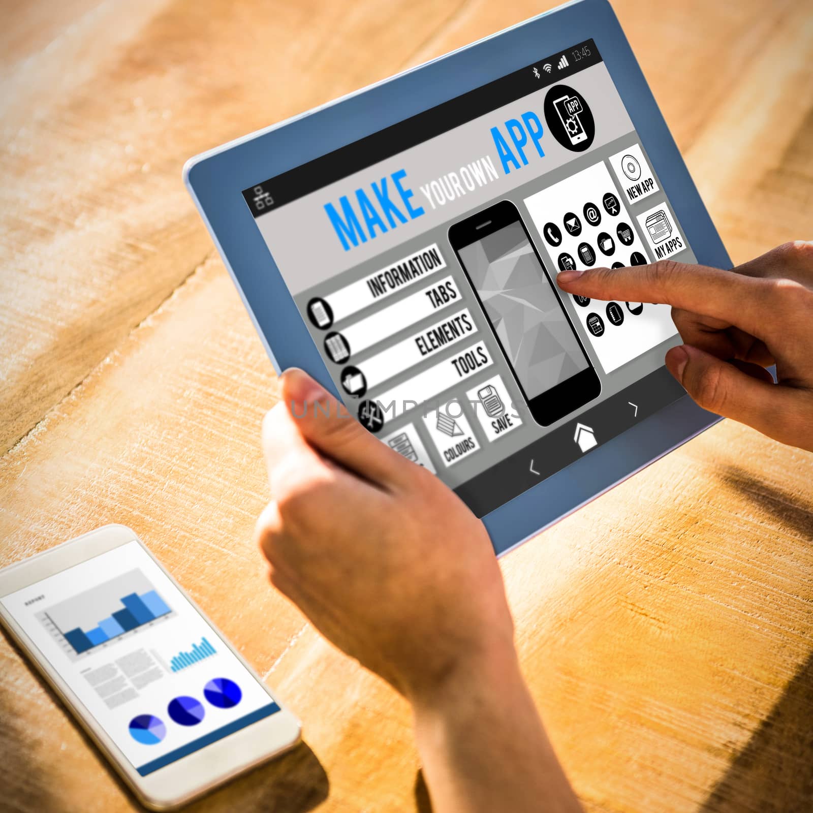 Make your own app smartphone against over shoulder view of casual man using tablet
