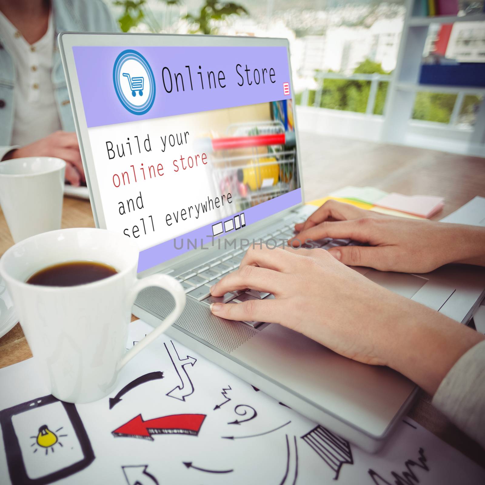 Screen of an online store against creative business team working together