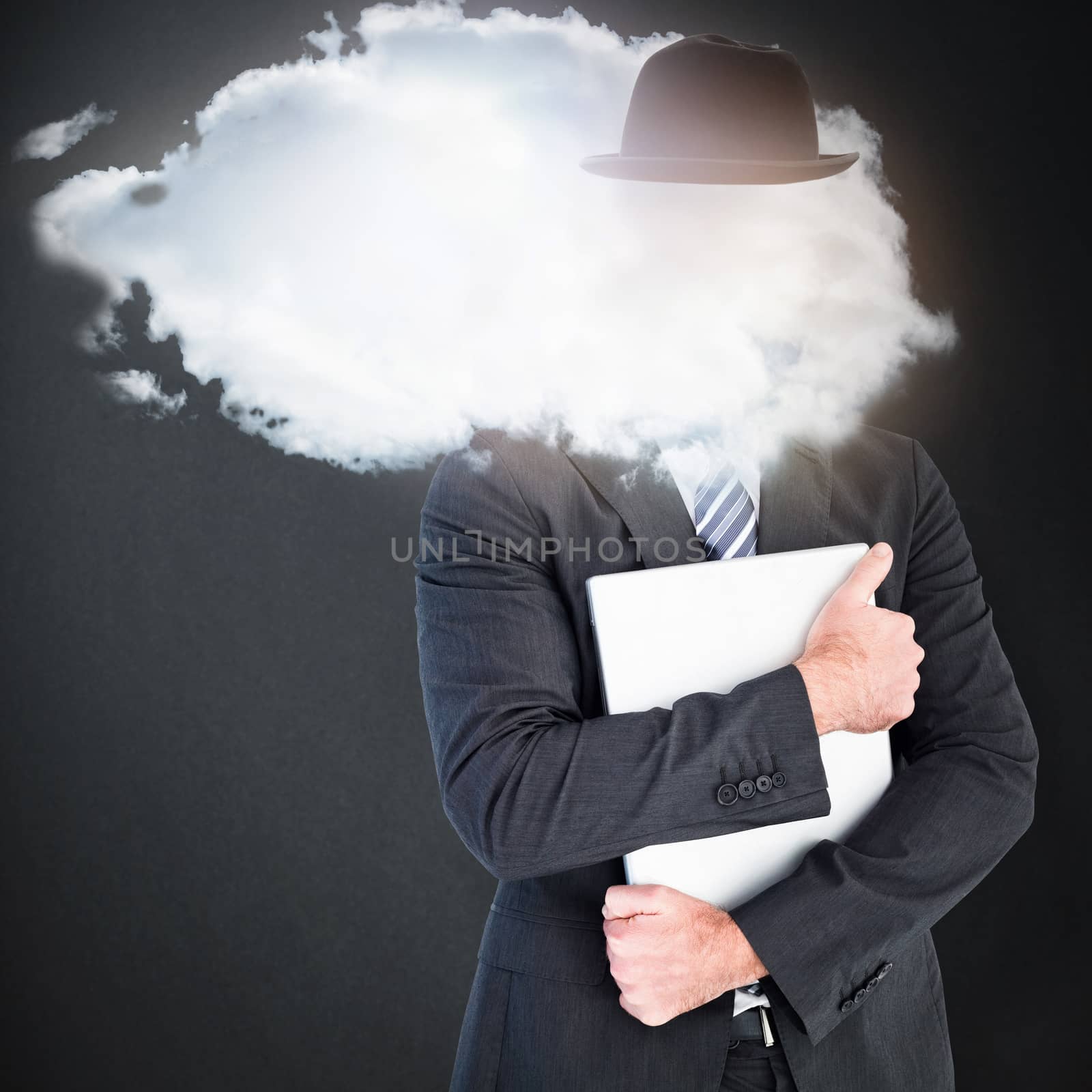 Businessman holding his laptop tightly against grey background