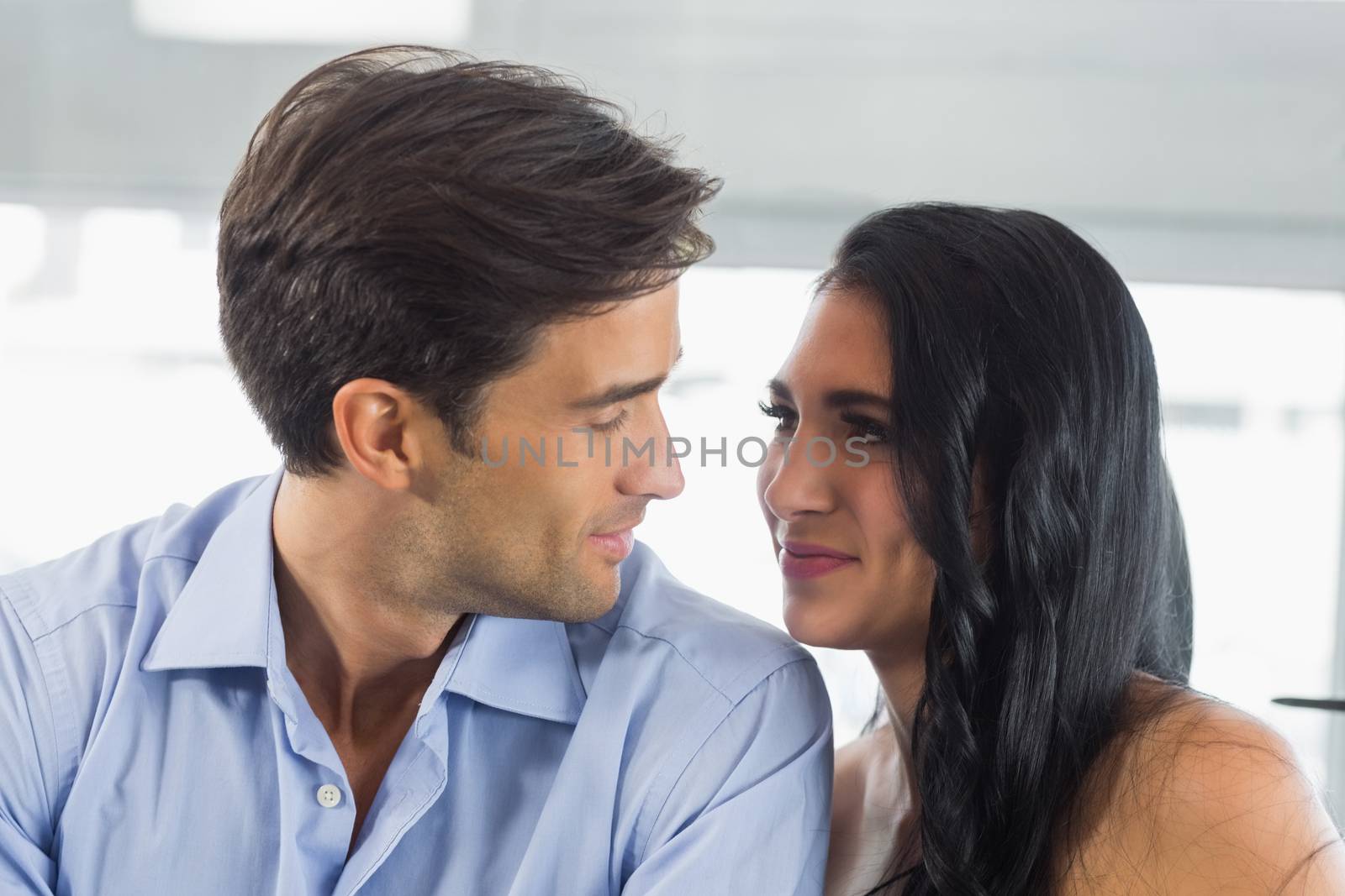 Romantic couple looking at each other in cafe