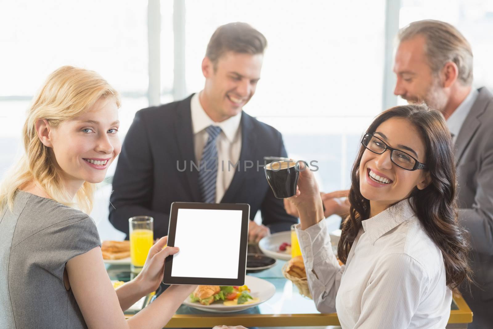 Business people having meal in restaurant by Wavebreakmedia