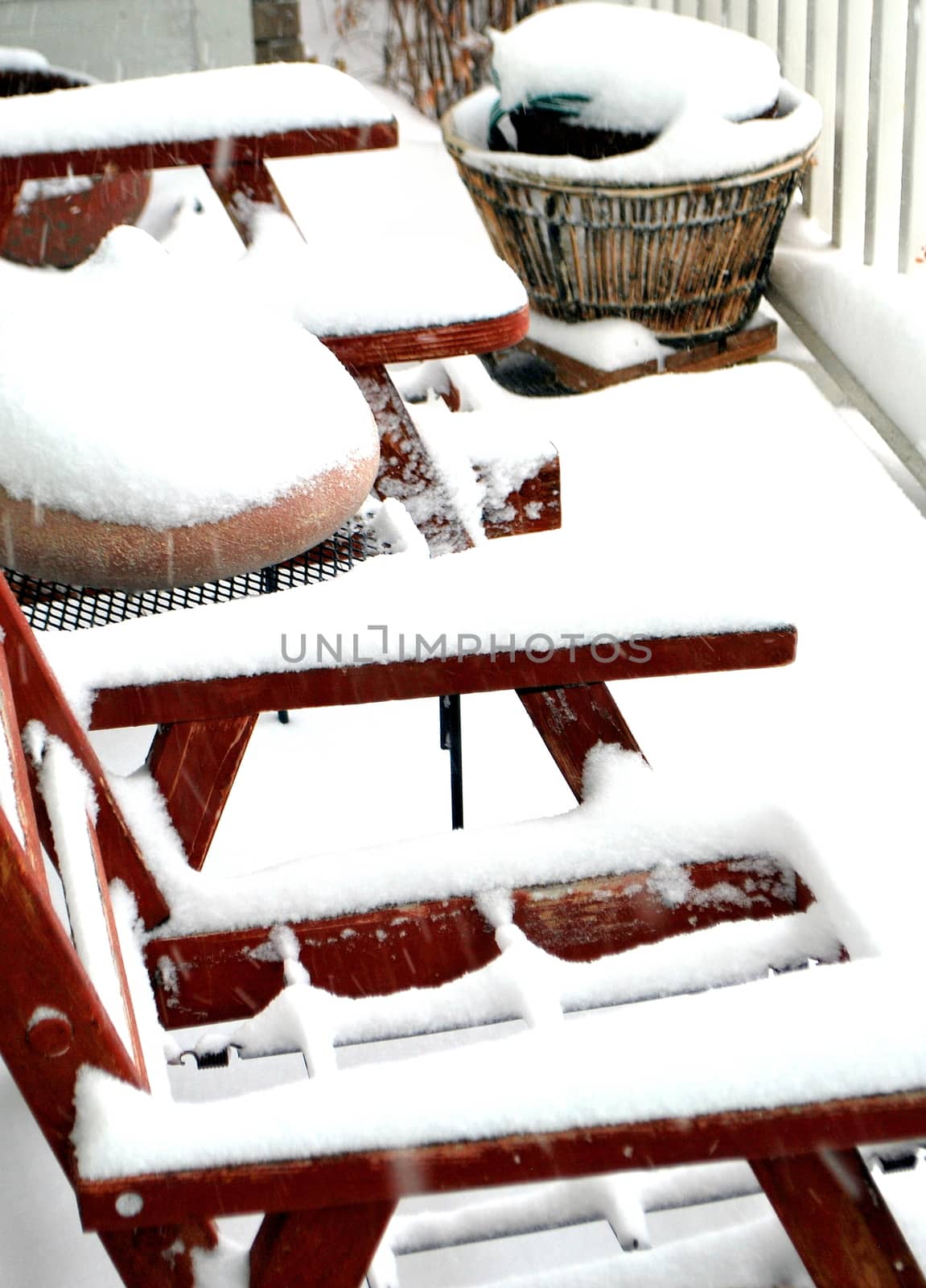Winter snow outside on patio deck.