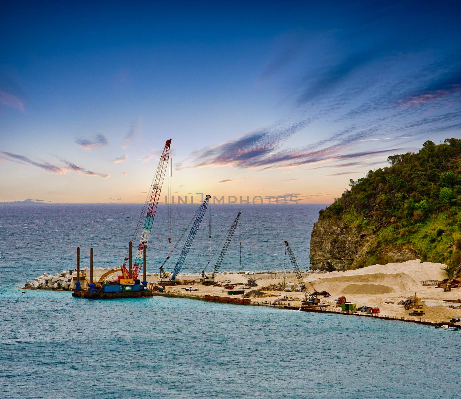 Construction cranes at a coastal construction site