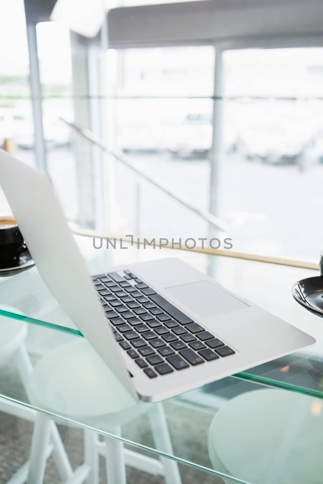 Close-up of a laptop on glass table by Wavebreakmedia