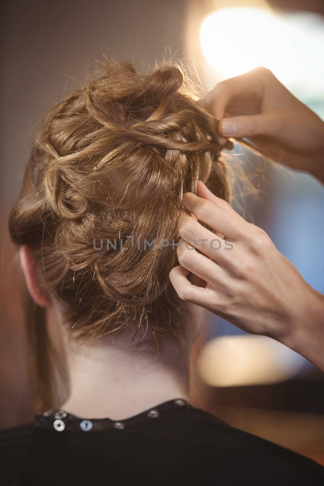 Female hairdresser styling customers hair at a salon