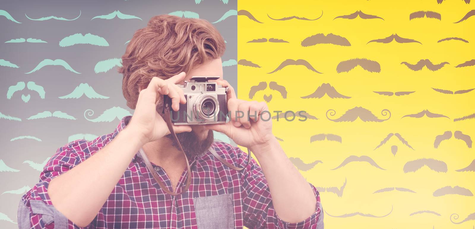 Hipster photographing with camera against composite image of mustaches