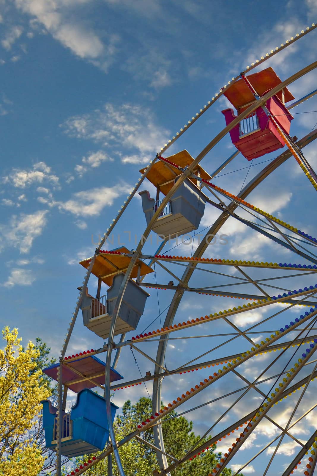 Ferris Wheel Against Dramatic Sky by dbvirago