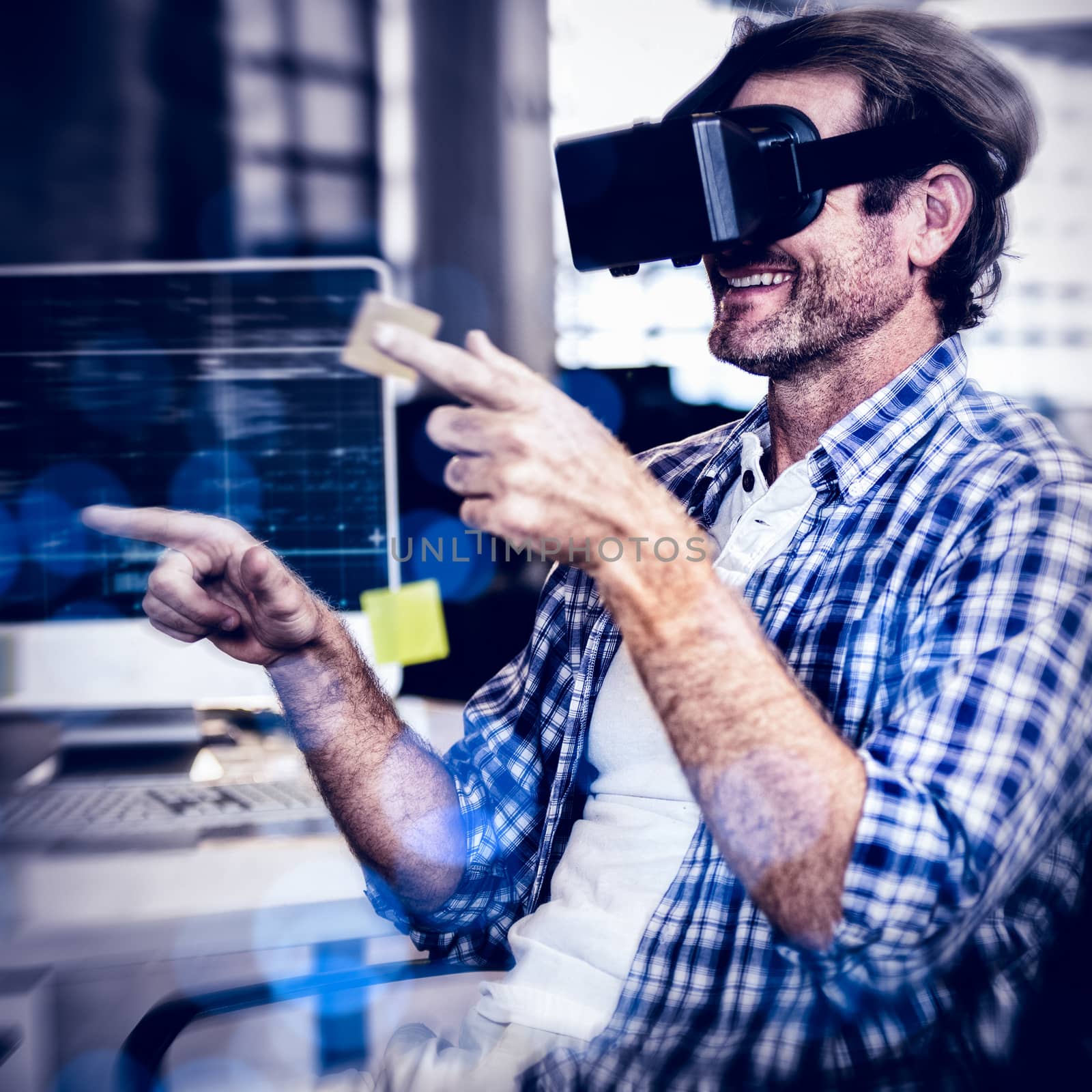 Creative businessman gesturing while using virtual reality simulator in office