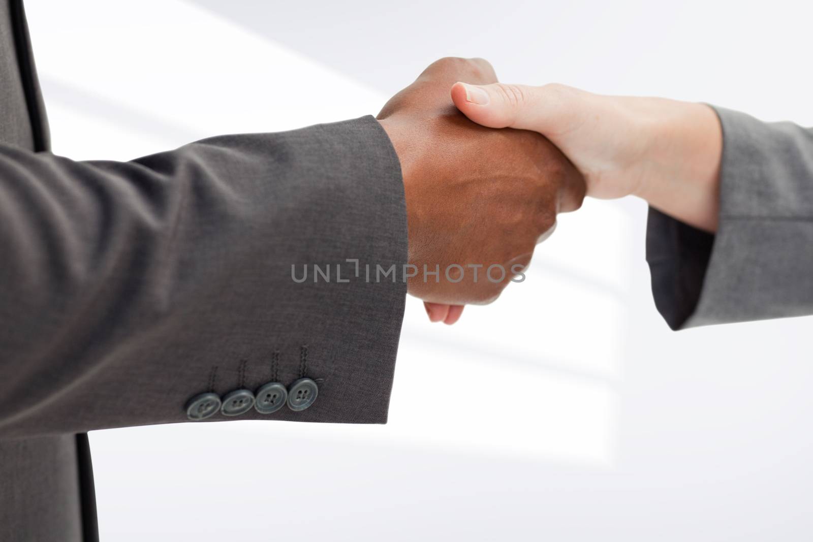 Business people giving a handshake against white background