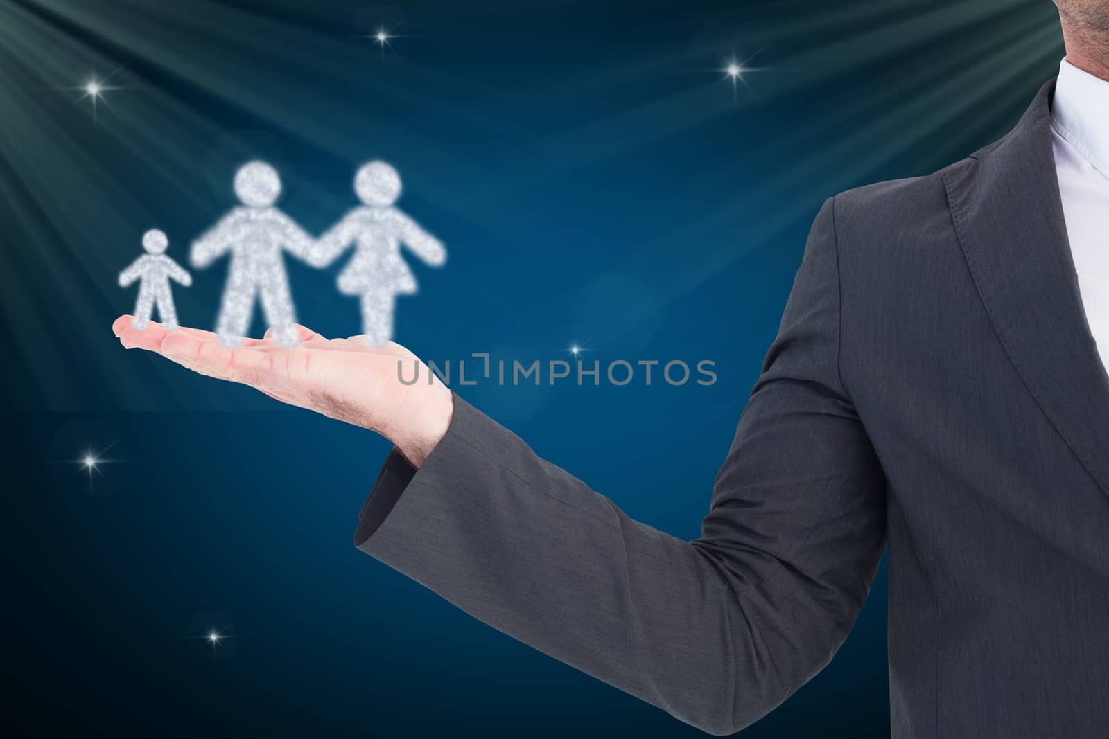 Businessman holding a family icon against blue background