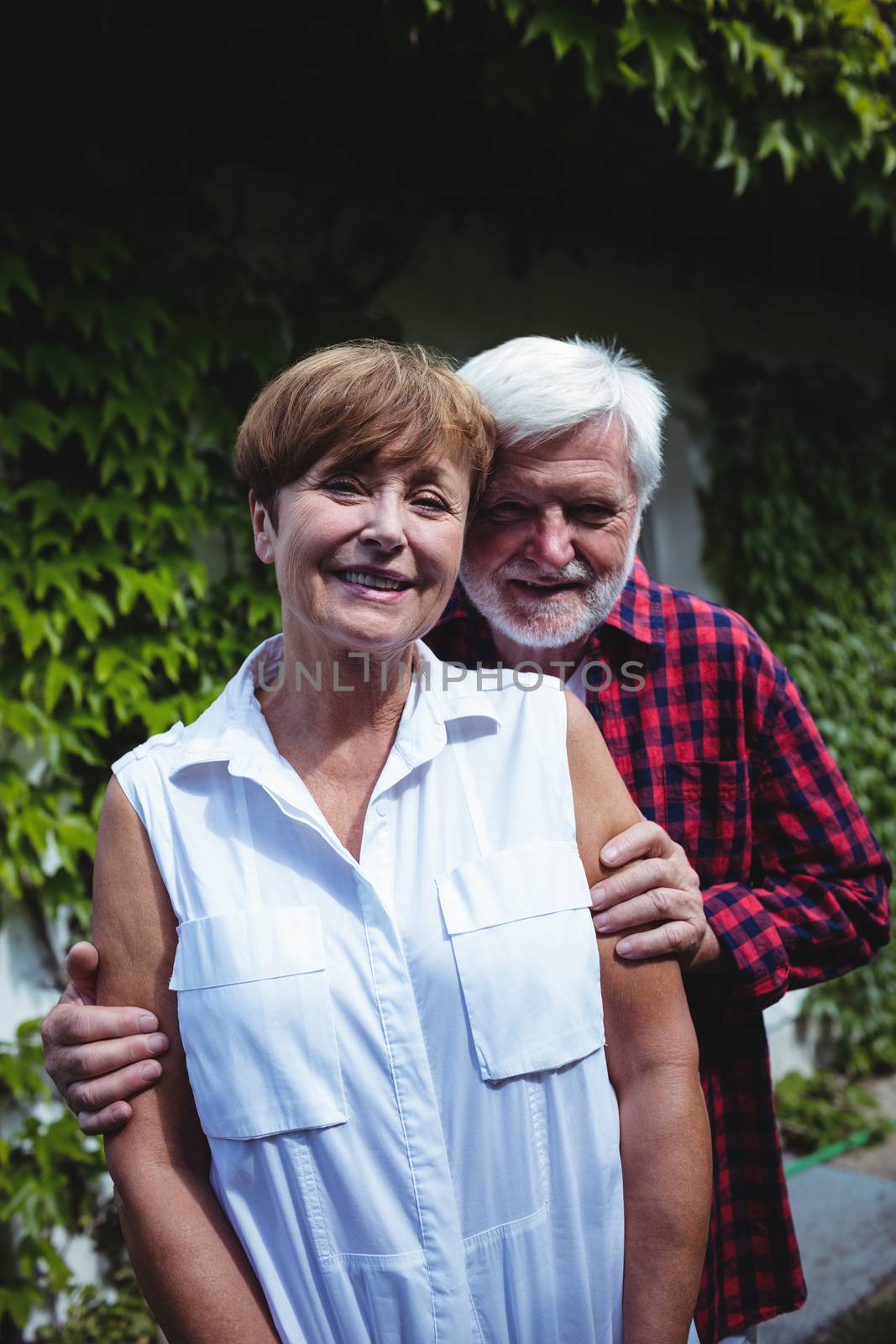 Senior couple smiling outdoors by Wavebreakmedia