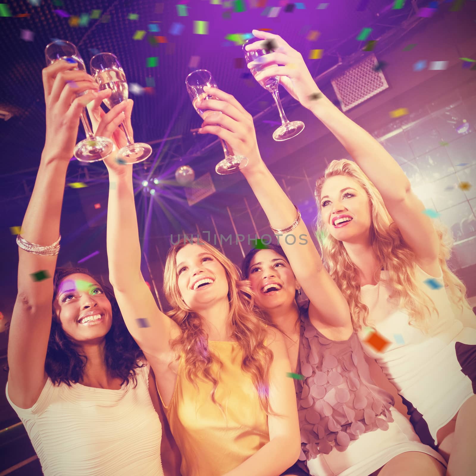 Pretty girls holding champagne glass against flying colours