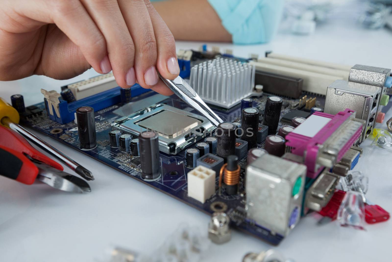 Female computer engineer repairing computer motherboard by Wavebreakmedia