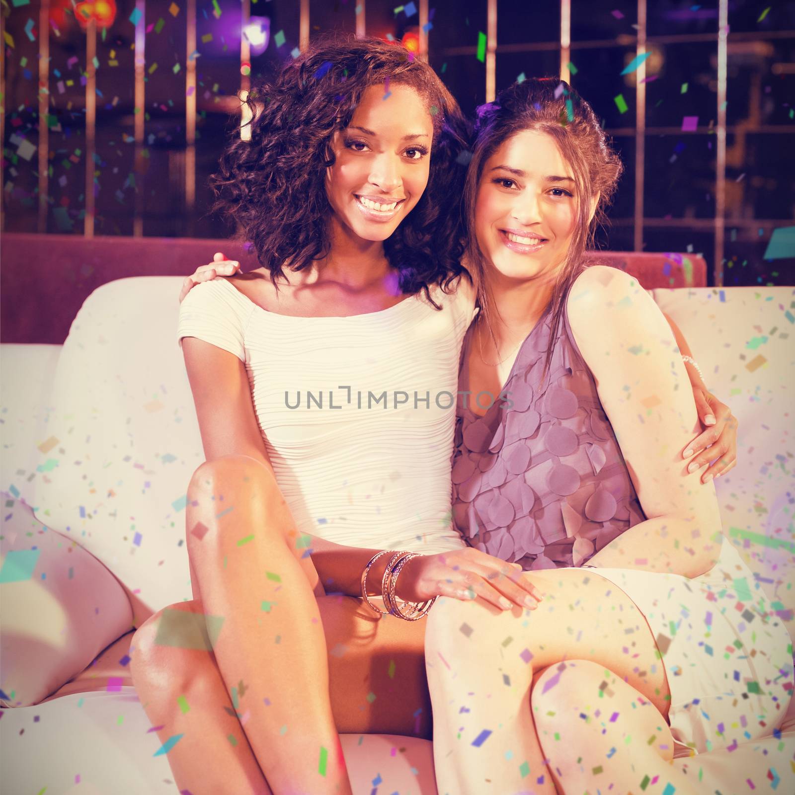 Pretty girls sitting on a couch against flying colours