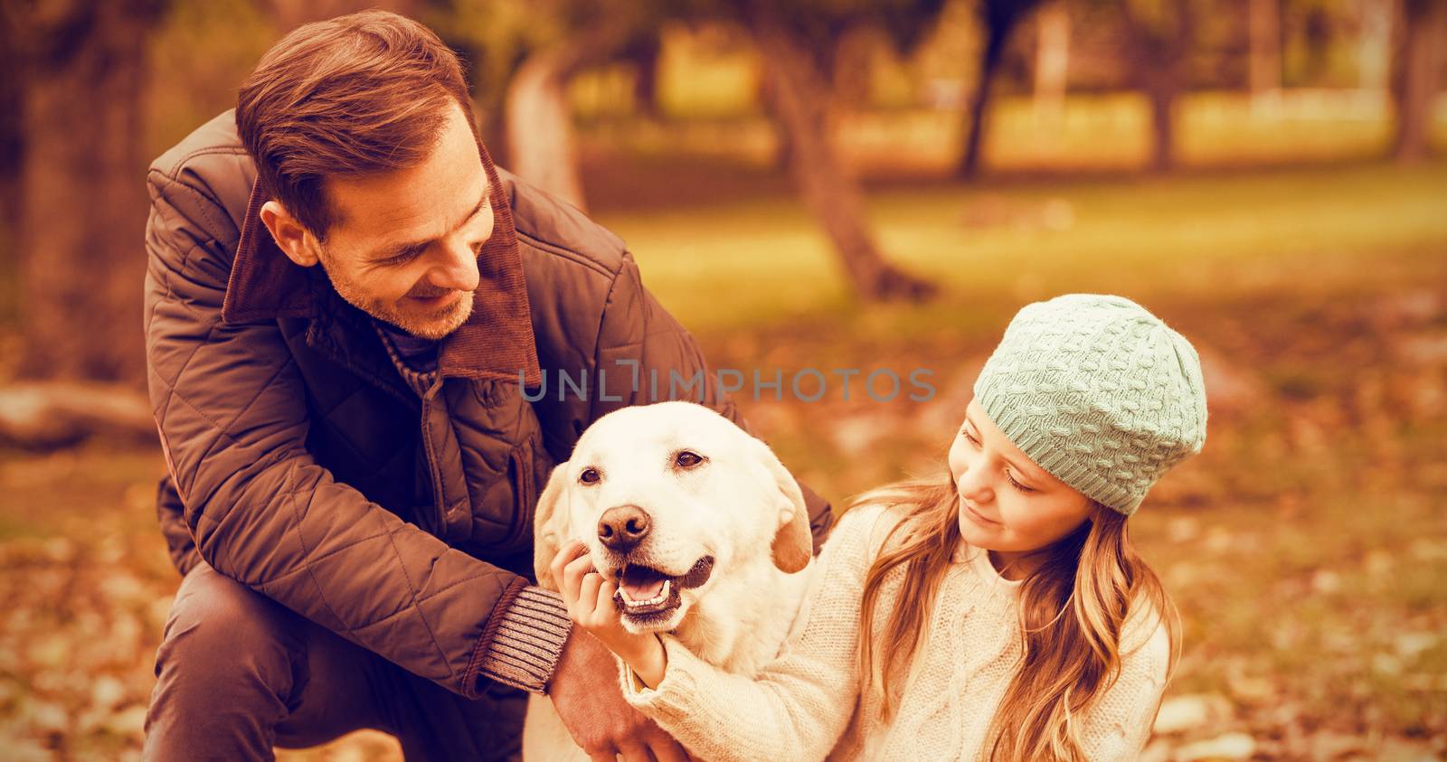 Young family with a dog on an autumns day