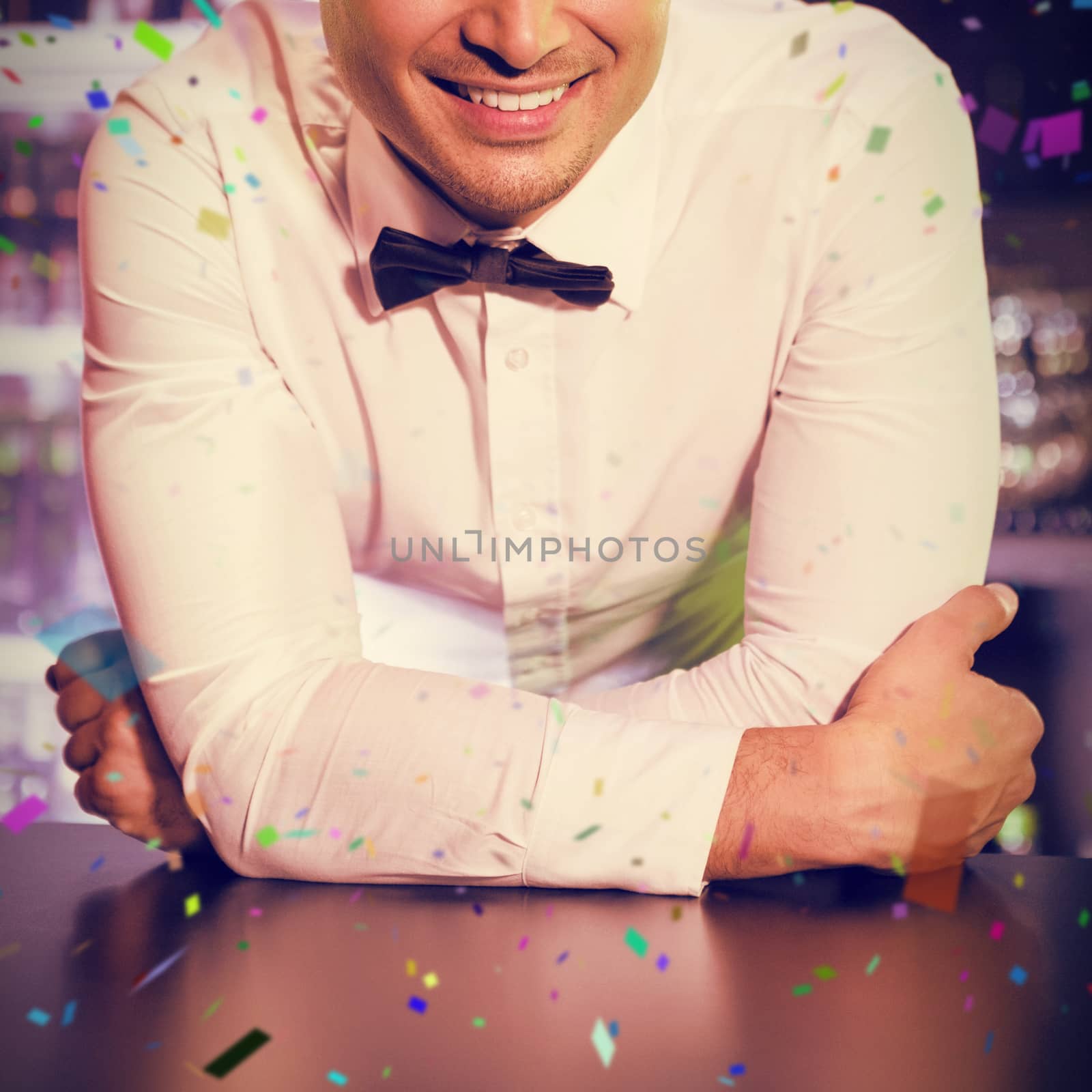 Portrait of smiling waiter  against flying colours