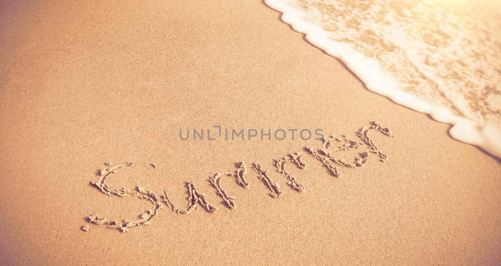 Summer written on sand with surf  at beach