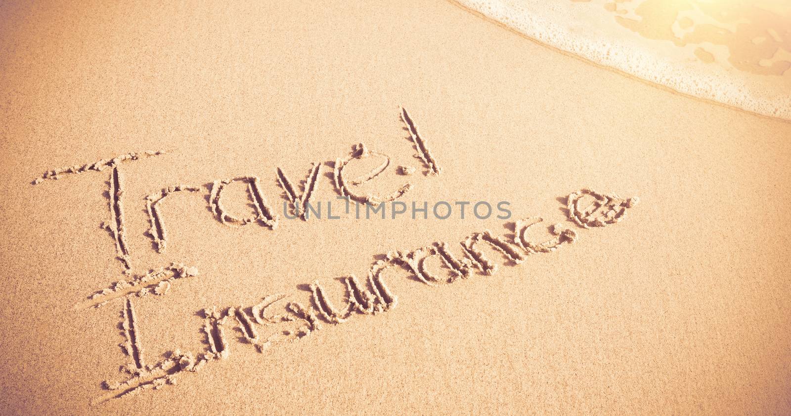 Travel Insurance written on sand at beach