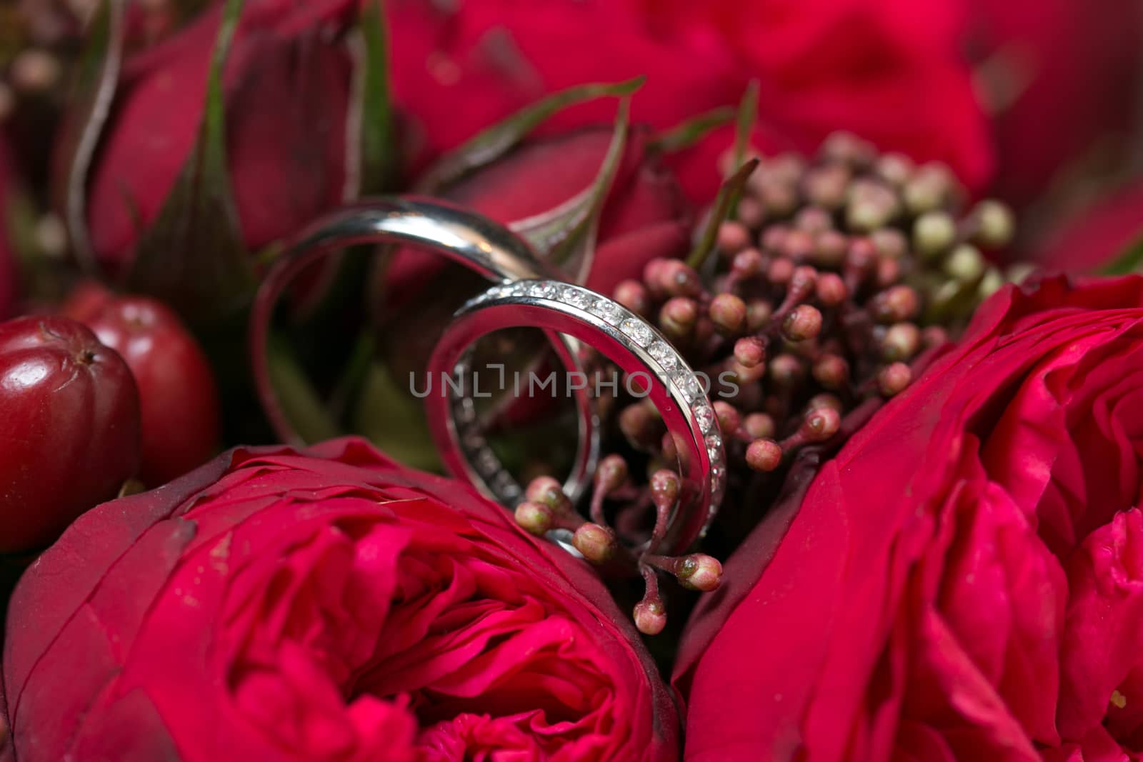Bridal bouquet made with red roses with wedding rings by sarymsakov