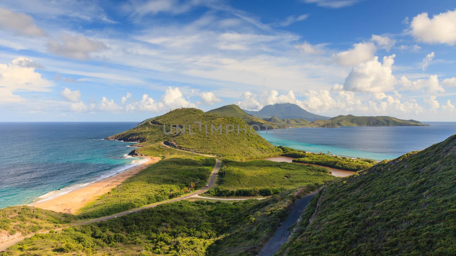 A panoramic view of the West Indian island of St Kitts.  To the left is the Atlantic Ocean, to the right is the Caribbean Ocean and in the background is the island of Nevis.