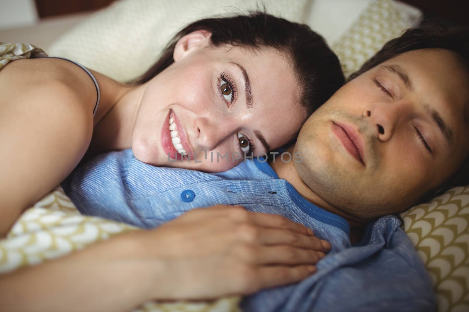 Romantic couple relaxing on bed in bedroom
