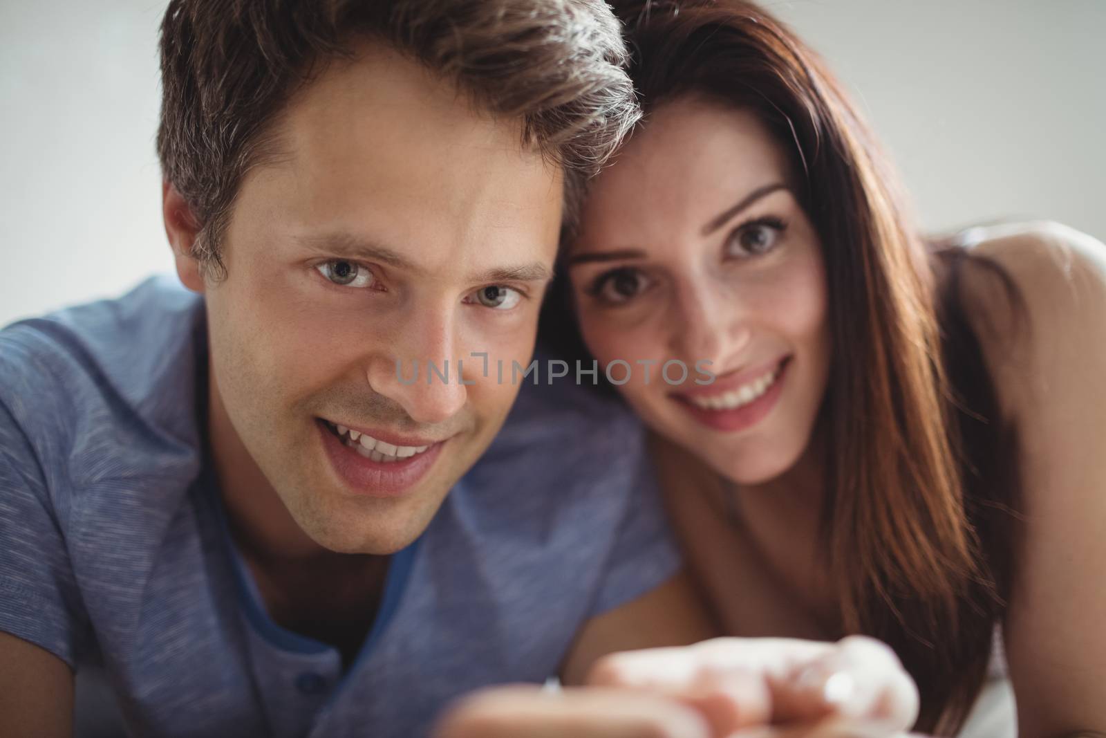 Romantic couple relaxing on bed by Wavebreakmedia