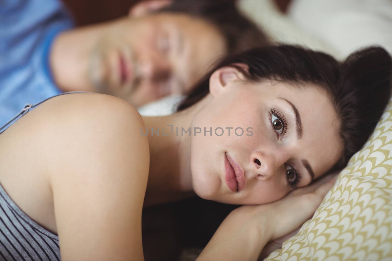 Romantic couple relaxing on bed by Wavebreakmedia