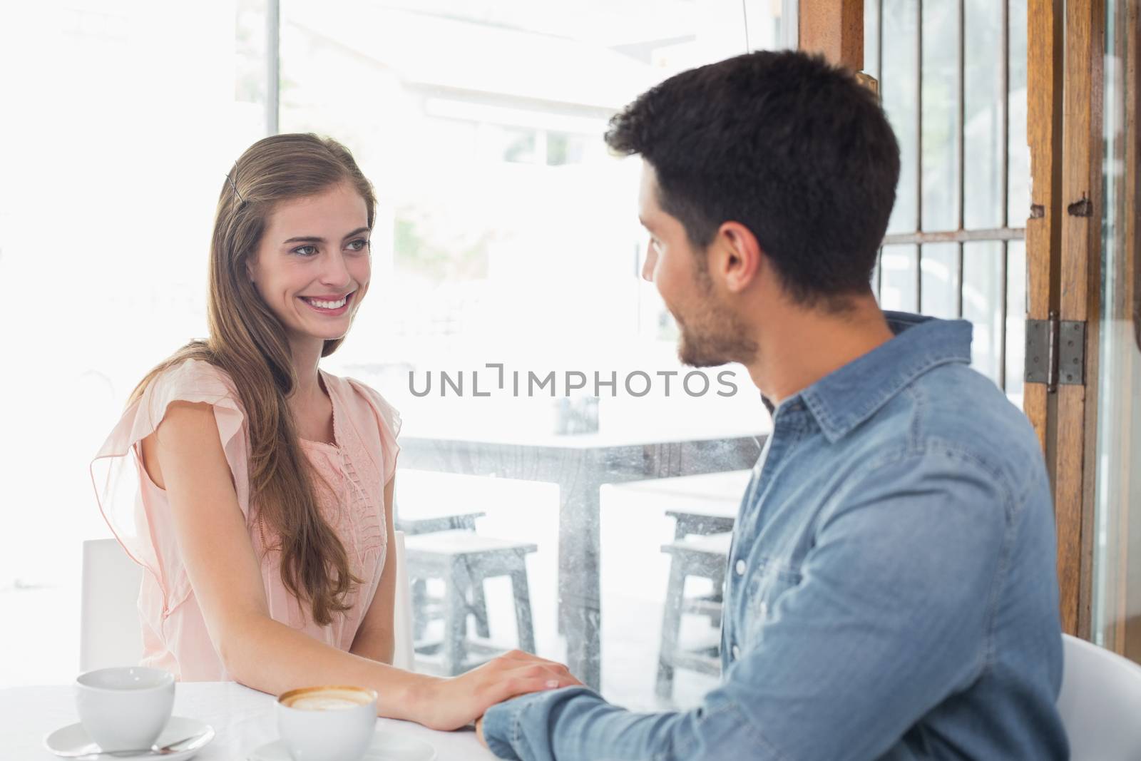 Romantic couple at coffee shop by Wavebreakmedia